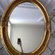 Grand miroir oval en stuc doré vintage