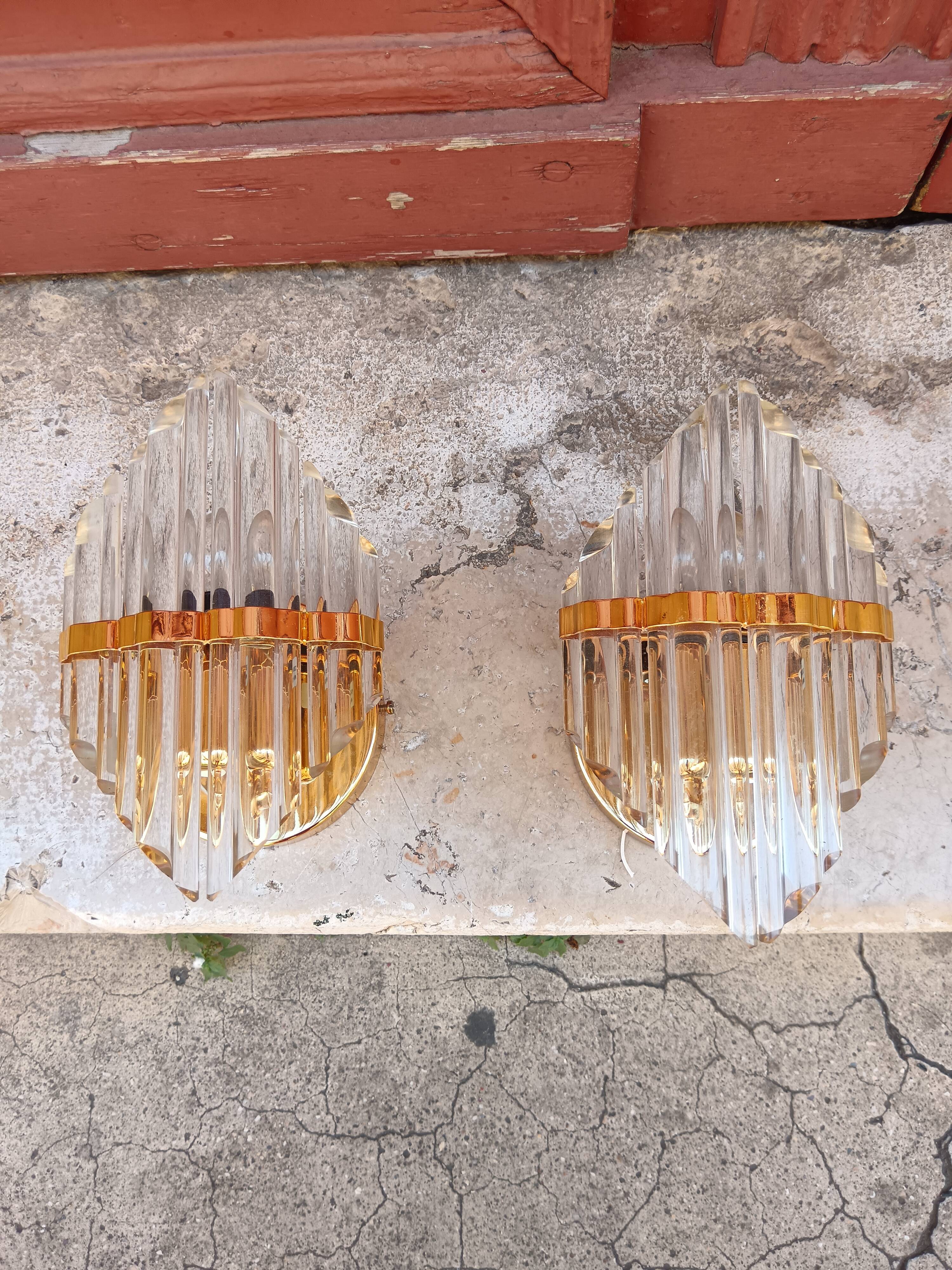 Pair of wall sconces in crystal glass and gilded brass. Venini style.
