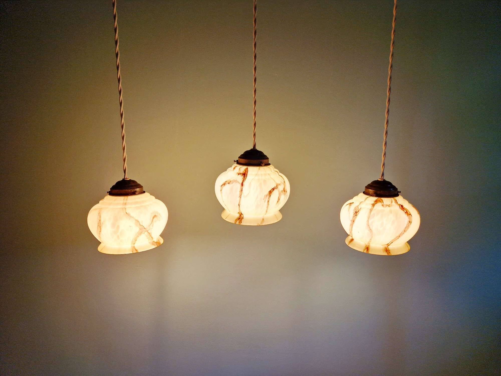 Trio of Art Deco marbled opaline pendant lights, 1920-30