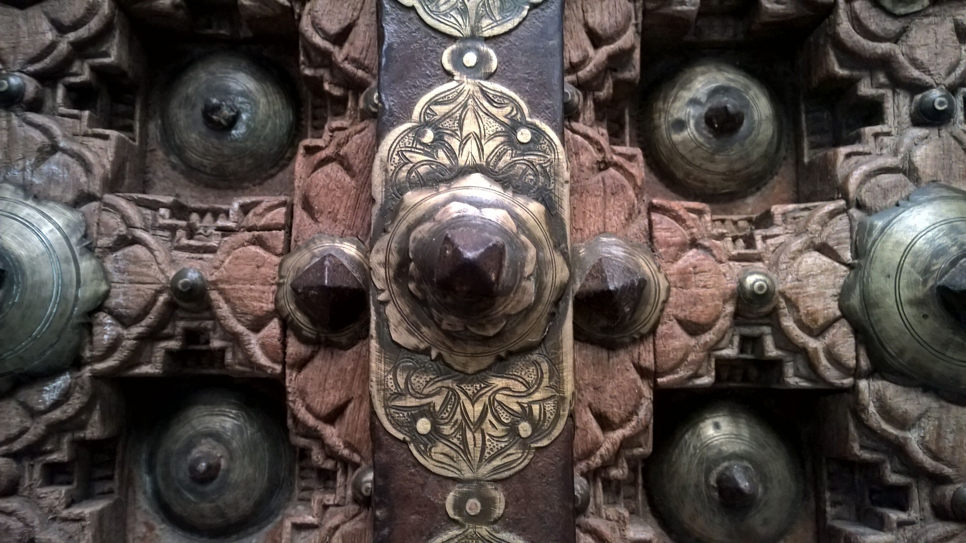 Old crafted teak and brass door