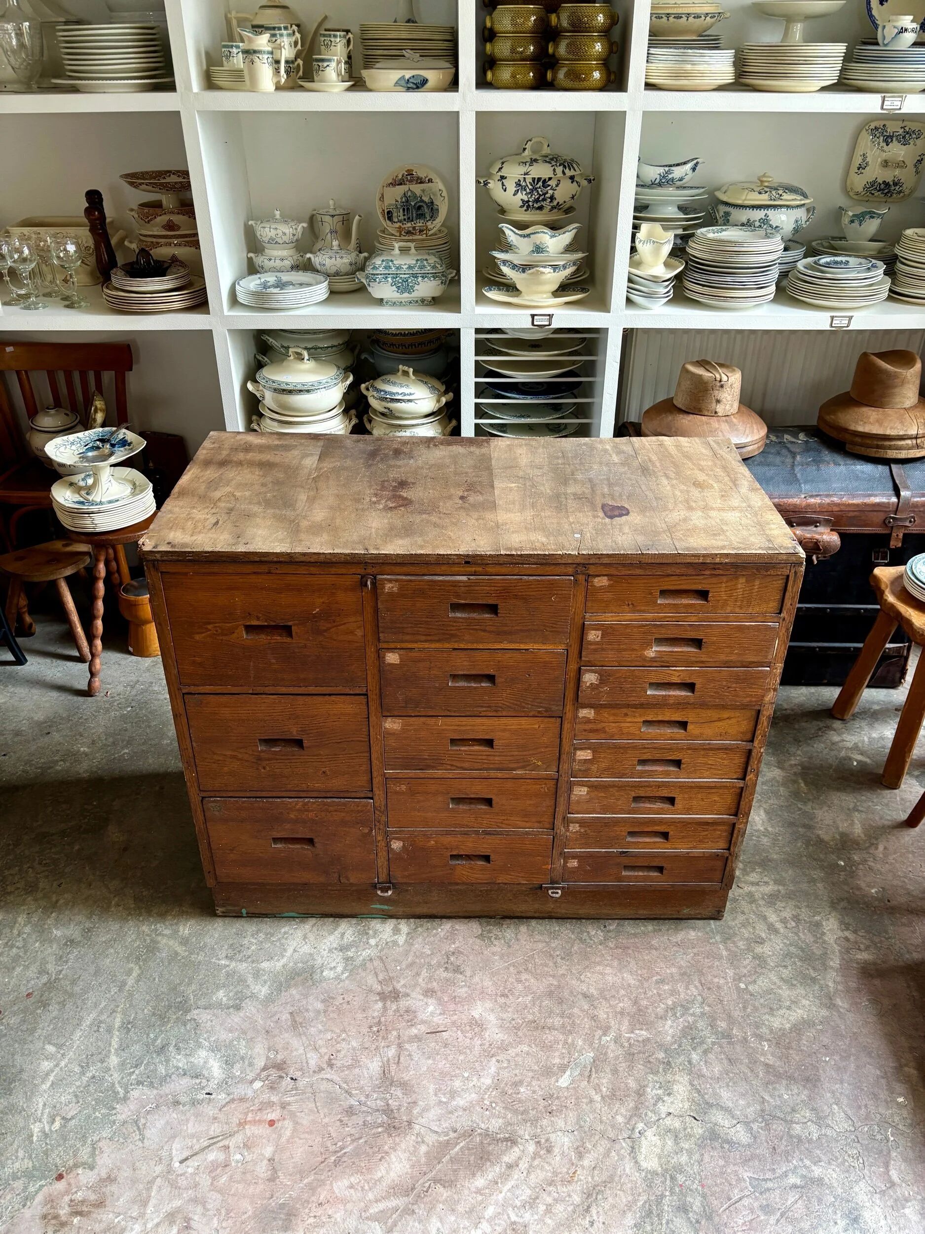 Craftsman's cabinet with 16 drawers in dark wood.