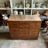Craftsman's cabinet with 16 drawers in dark wood.