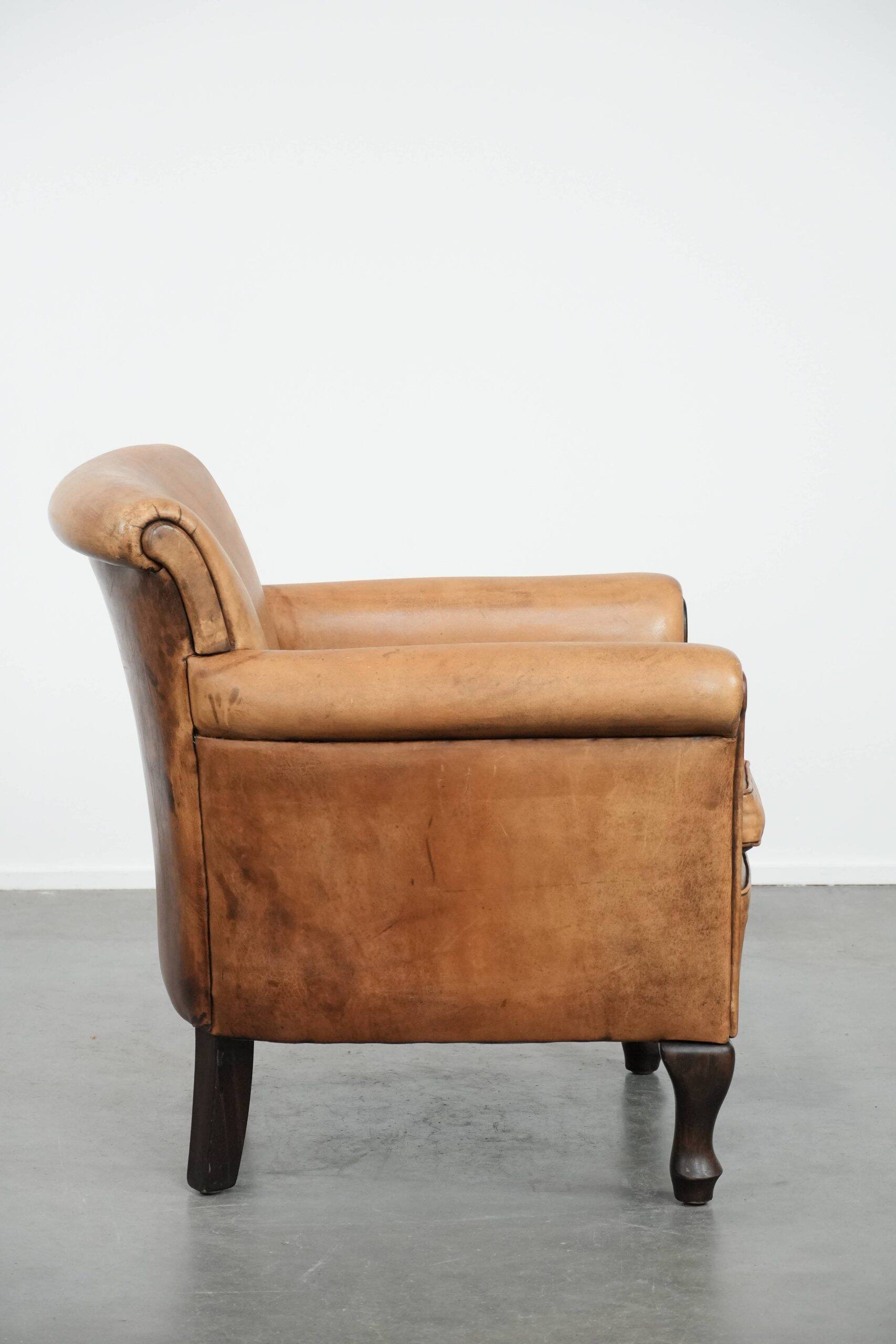Vintage sheepskin armchair with a beautiful light colour and elegant legs