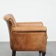 Vintage sheepskin armchair with a beautiful light colour and elegant legs