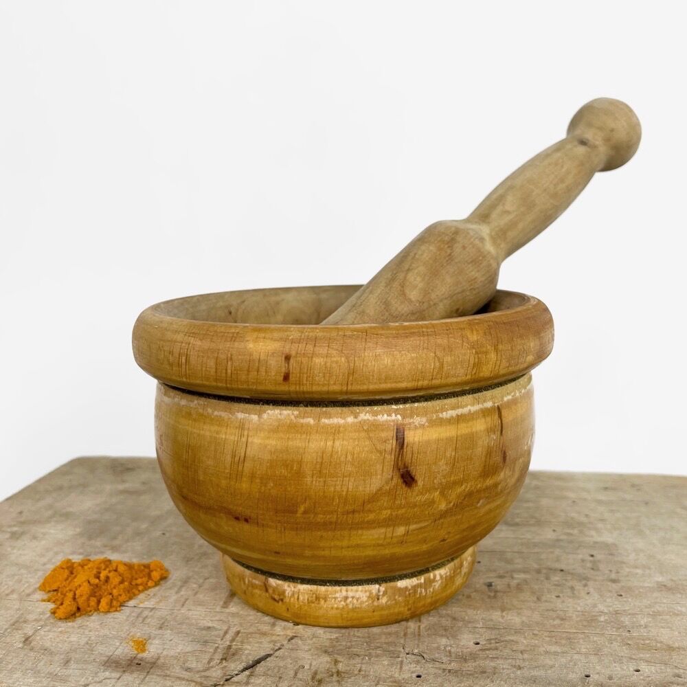 Mortar and old pestle made of olive wood