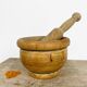Mortar and old pestle made of olive wood