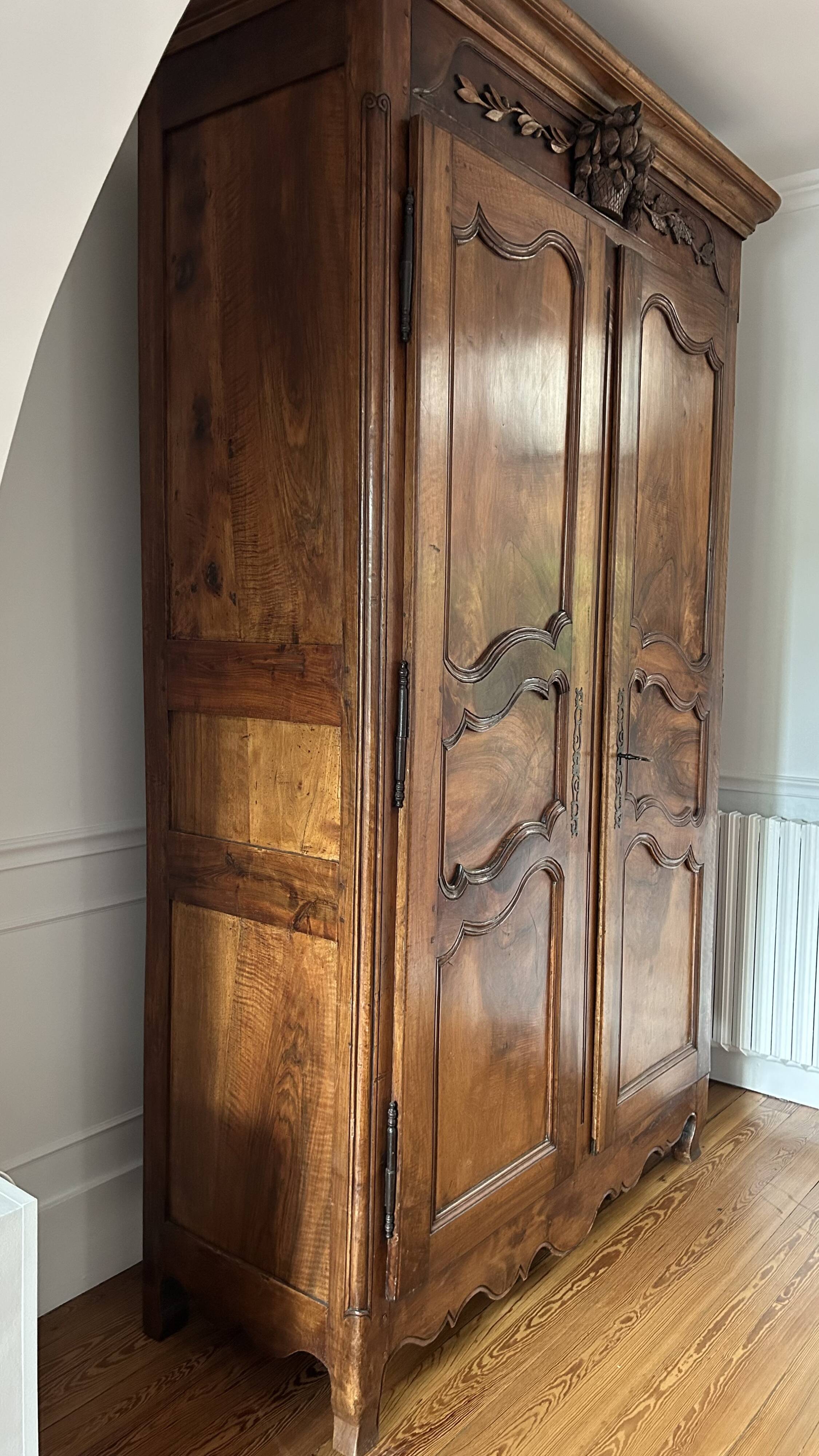 Antique walnut armoire with two doors.