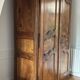 Antique walnut armoire with two doors.