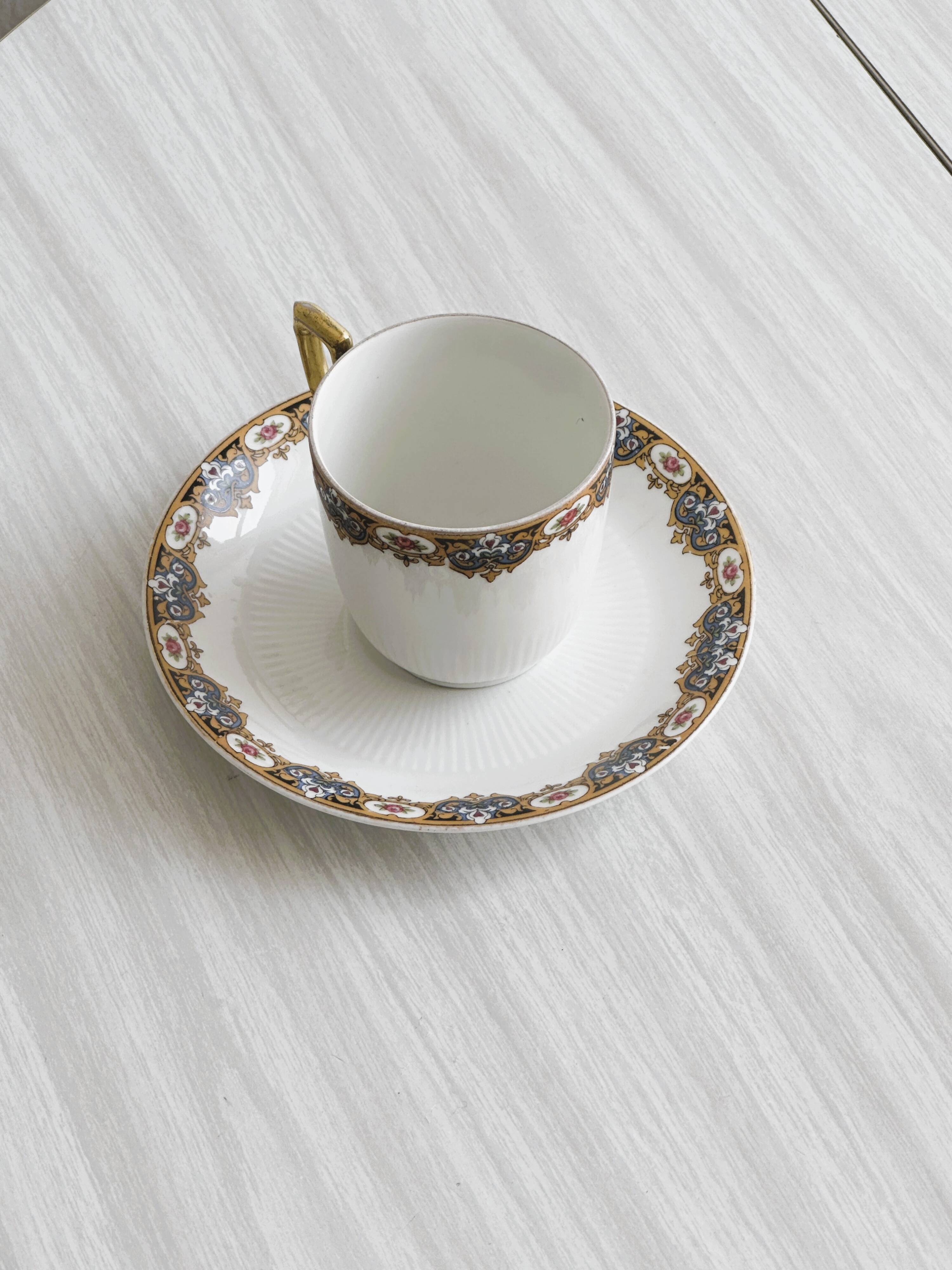 7 Limoges porcelain cups and saucers with gold decoration and floral motif.