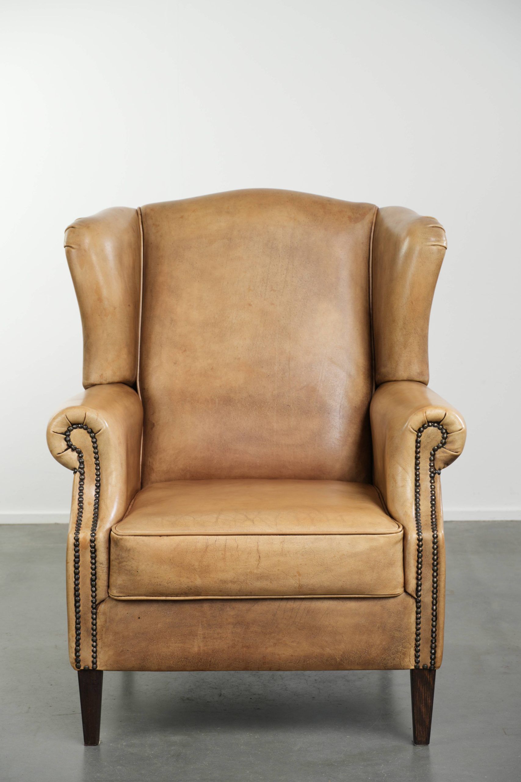 Comfortable cowhide wingback armchair with a timeless English look