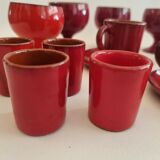 Red enamelled terracotta: cups, saucers, glasses