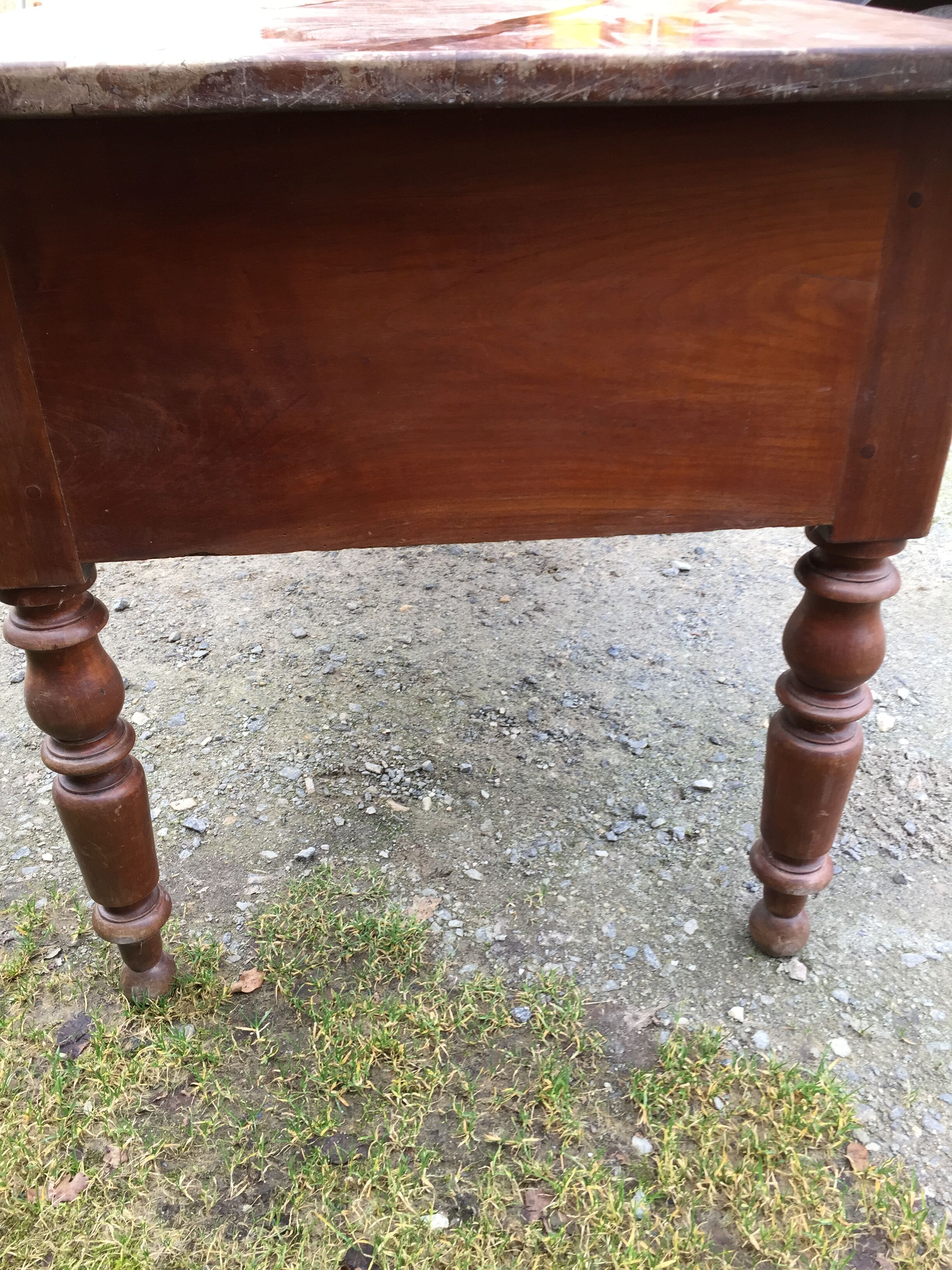 Old farmhouse table with cherry and chestnut panels with 3 drawers.