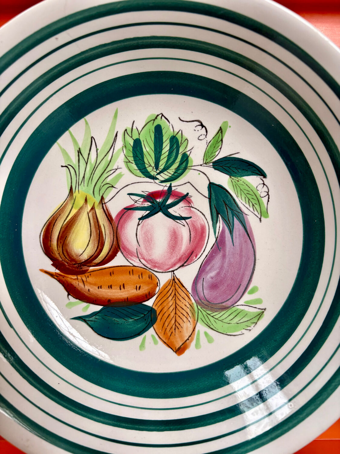 Vintage deep plate with vegetable decoration.