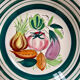 Vintage deep plate with vegetable decoration.
