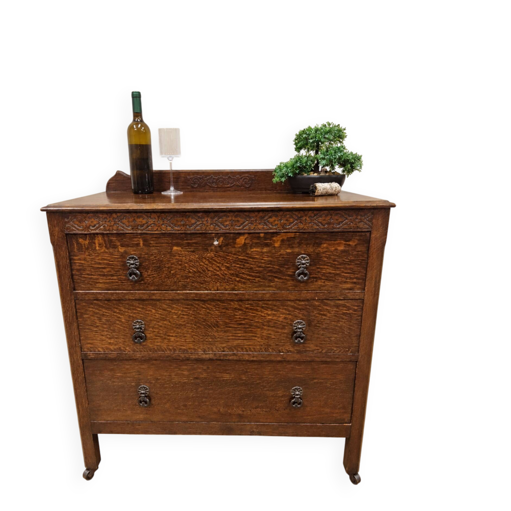 Antique chest of drawers on wheels with wood carving (key top drawer)