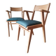 Scandinavian armchairs with green tapered legs.