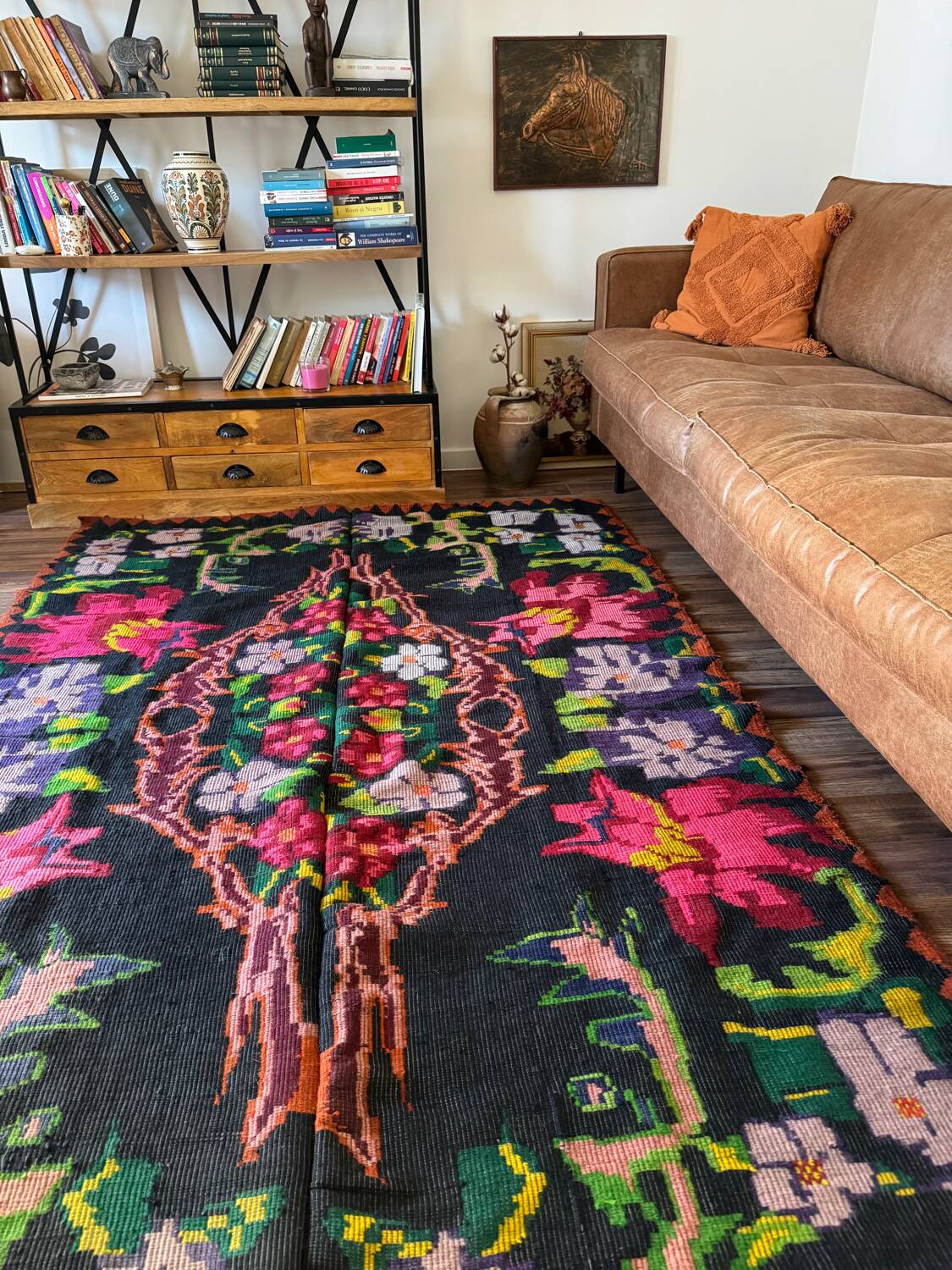 Bohemian floral design, handwoven wool rug, black background with colorful flowers