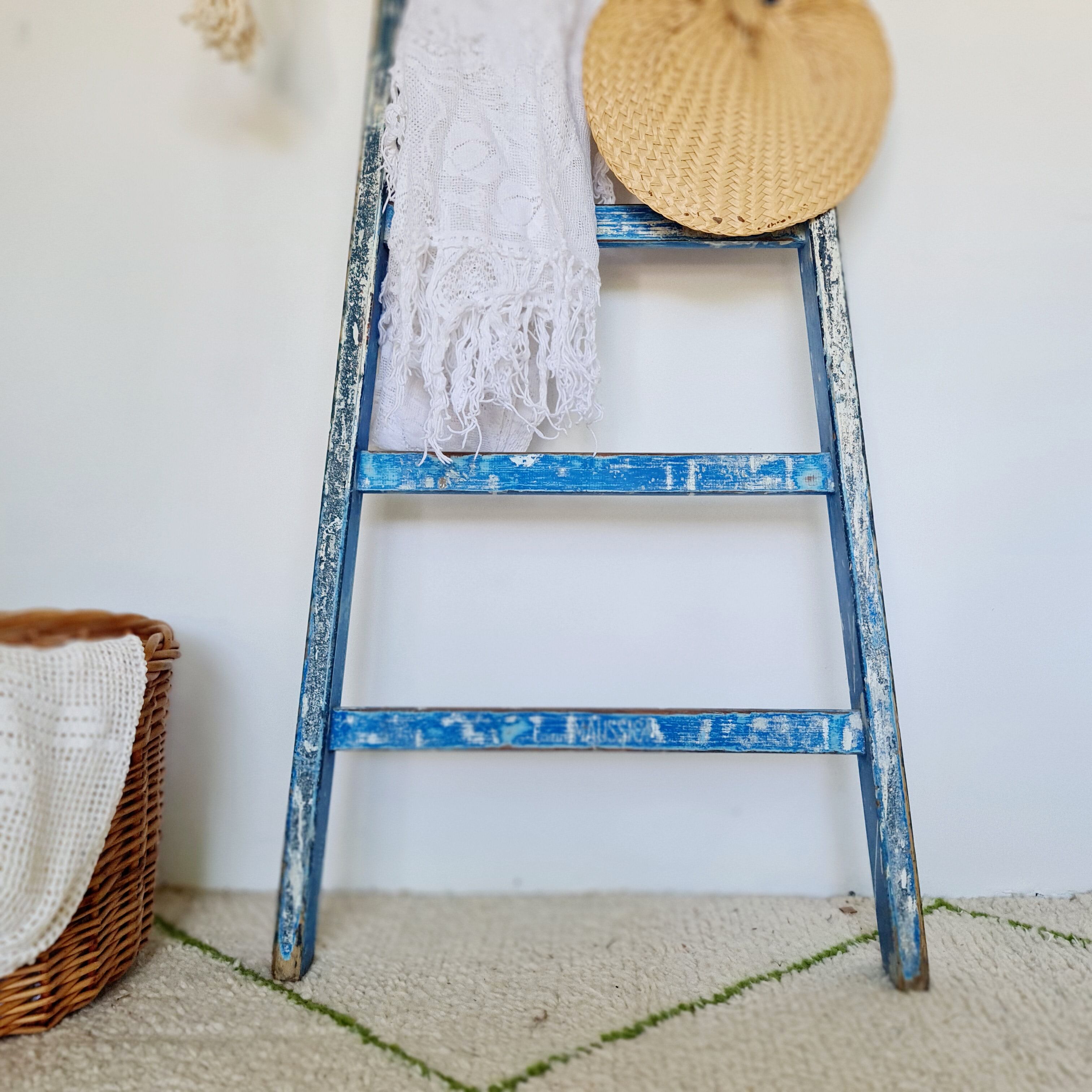 Old ladder in blue wood