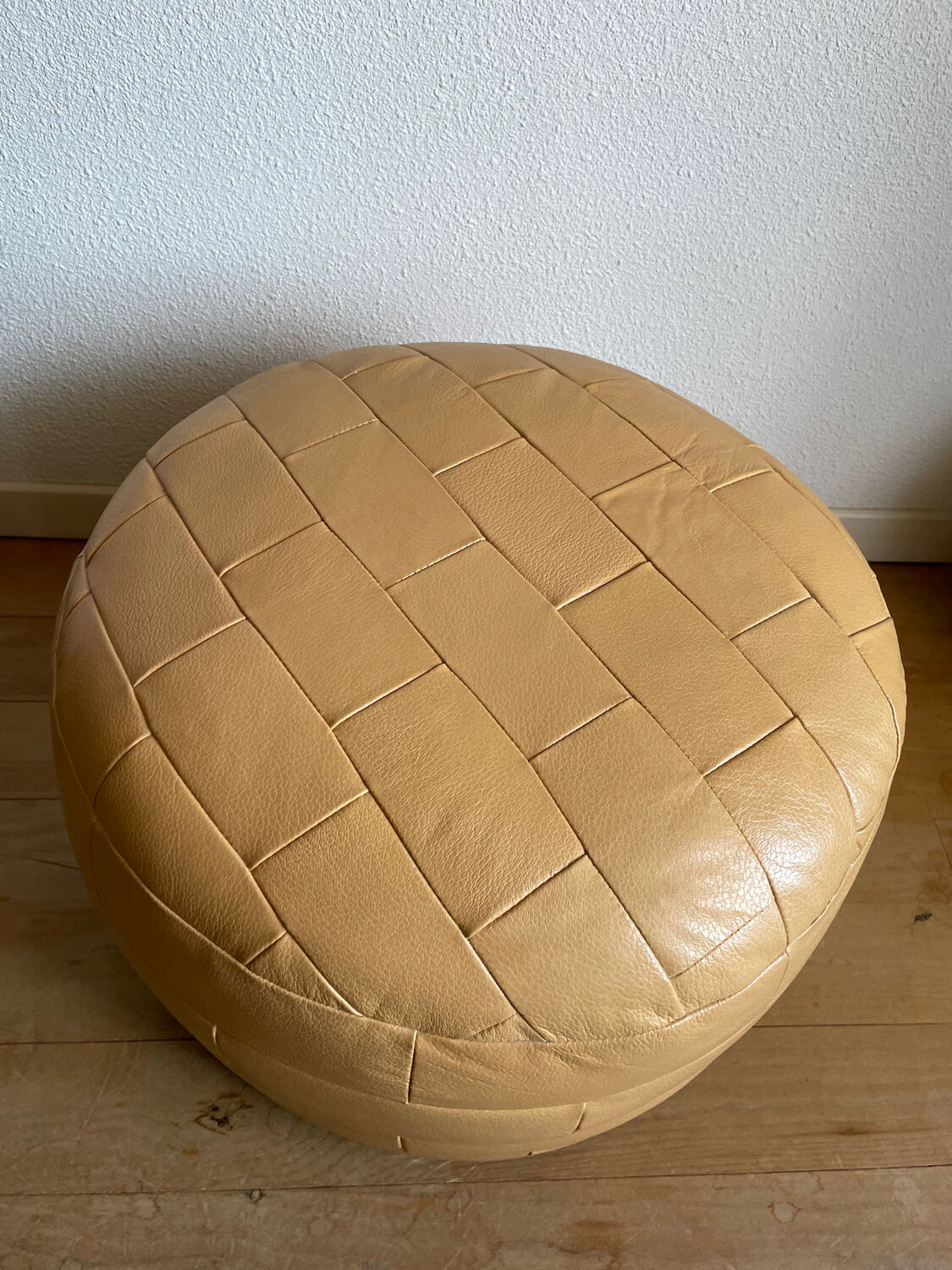 Beige patchwork leather pouf from Sède