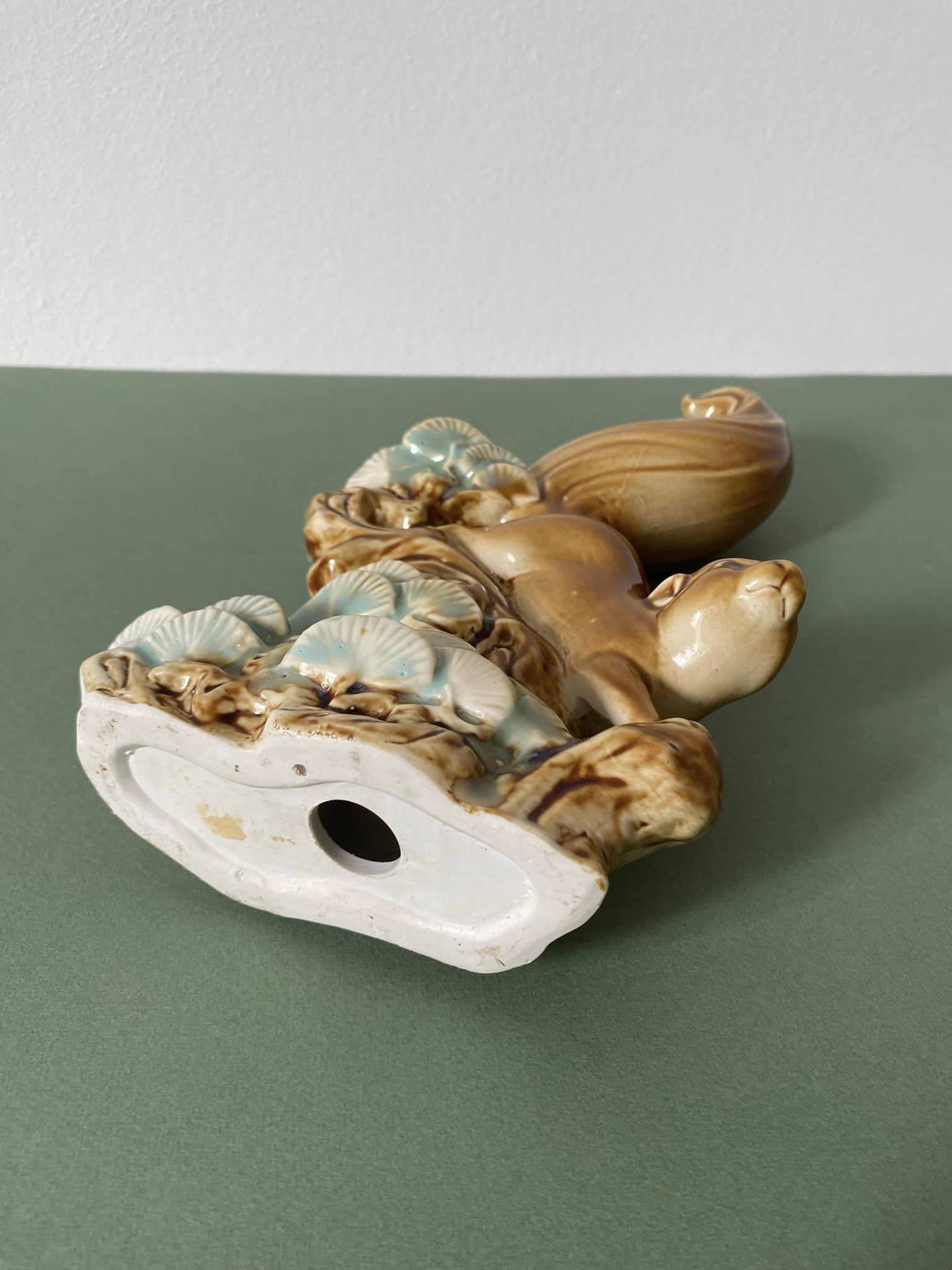 Ceramic squirrel on branch