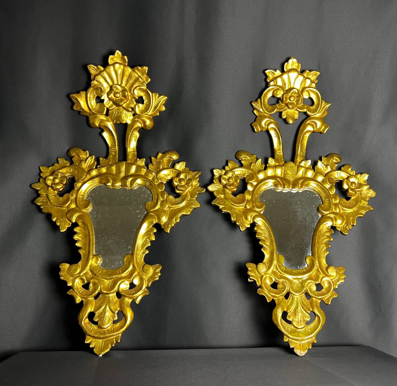 Pair of carved and gilded wooden mirrors, Italian Baroque style, 19th century.