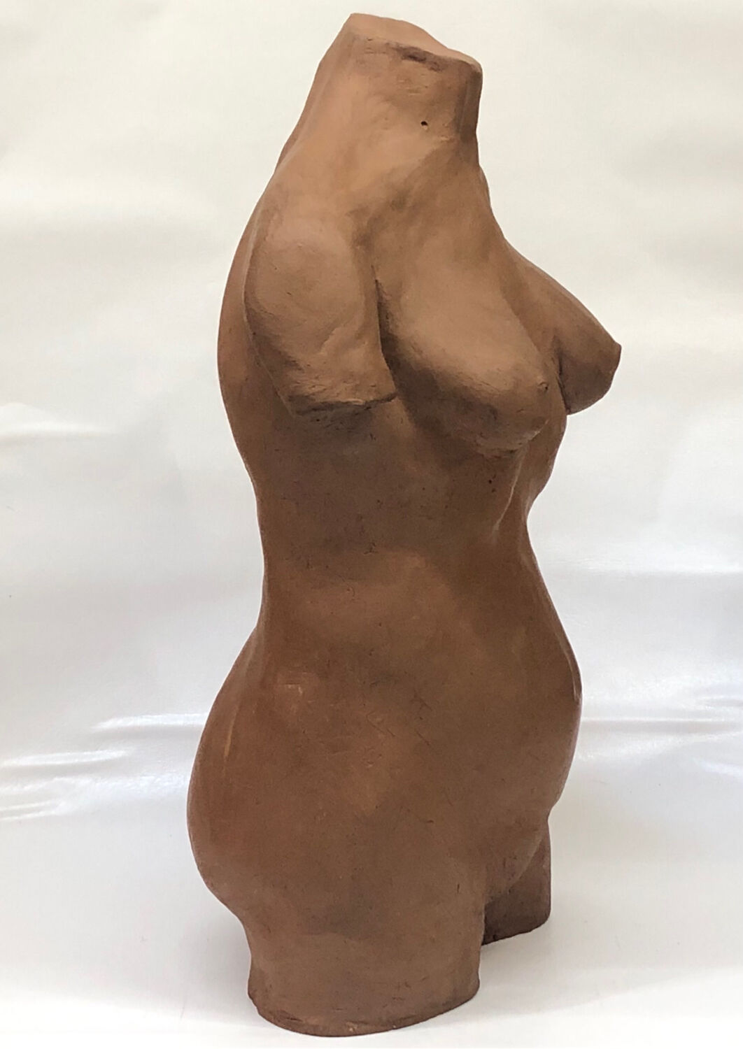 School bust of a female body in red clay terracotta