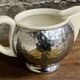 Ceramic/tinned milk jug.
