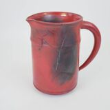Red glazed ceramic jug with relief