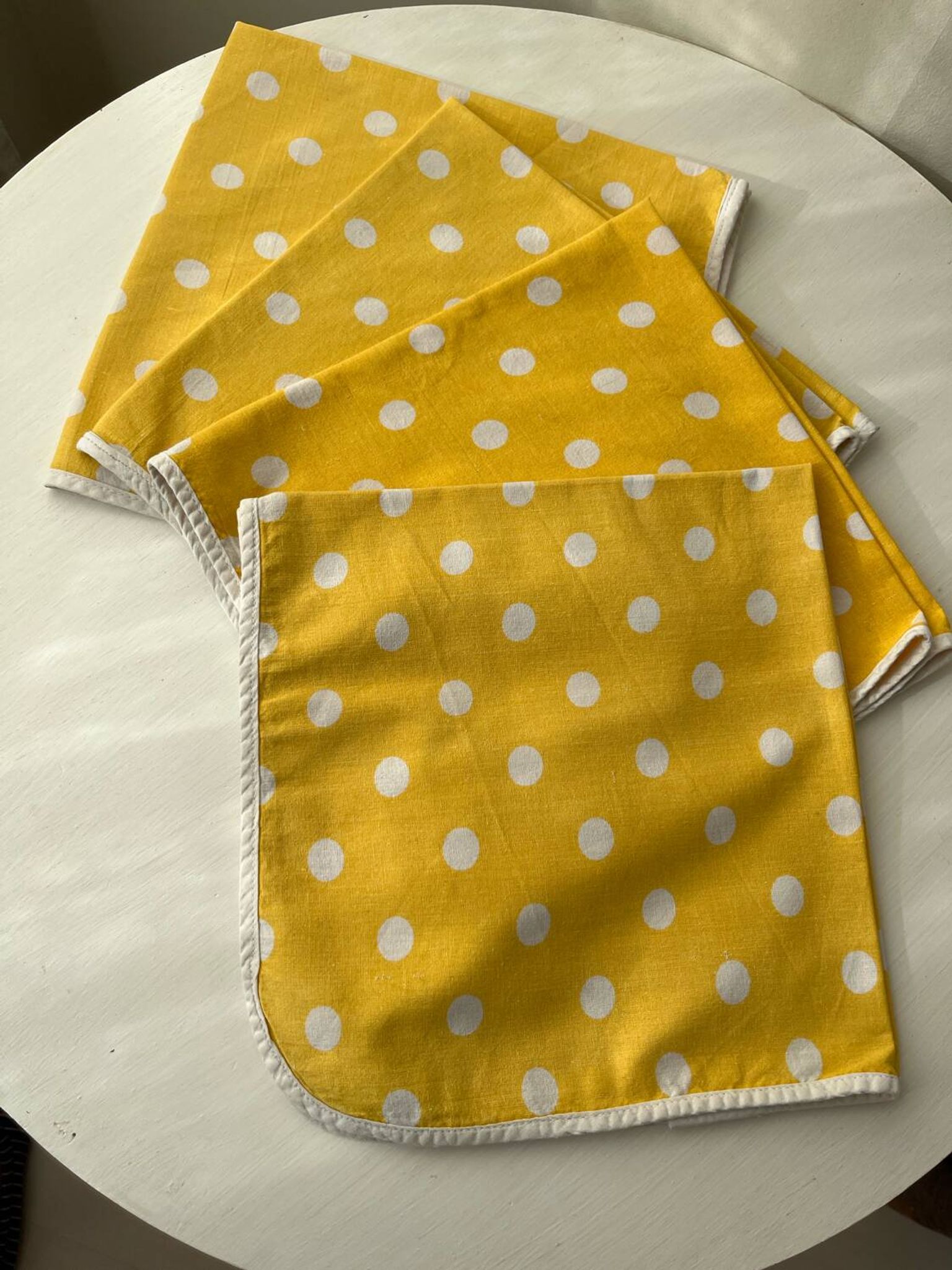 4 yellow napkins with white polka dots