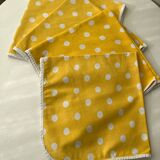 4 yellow napkins with white polka dots