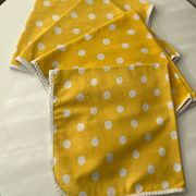 4 yellow napkins with white polka dots