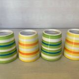 Four striped egg cups in yellow and green.