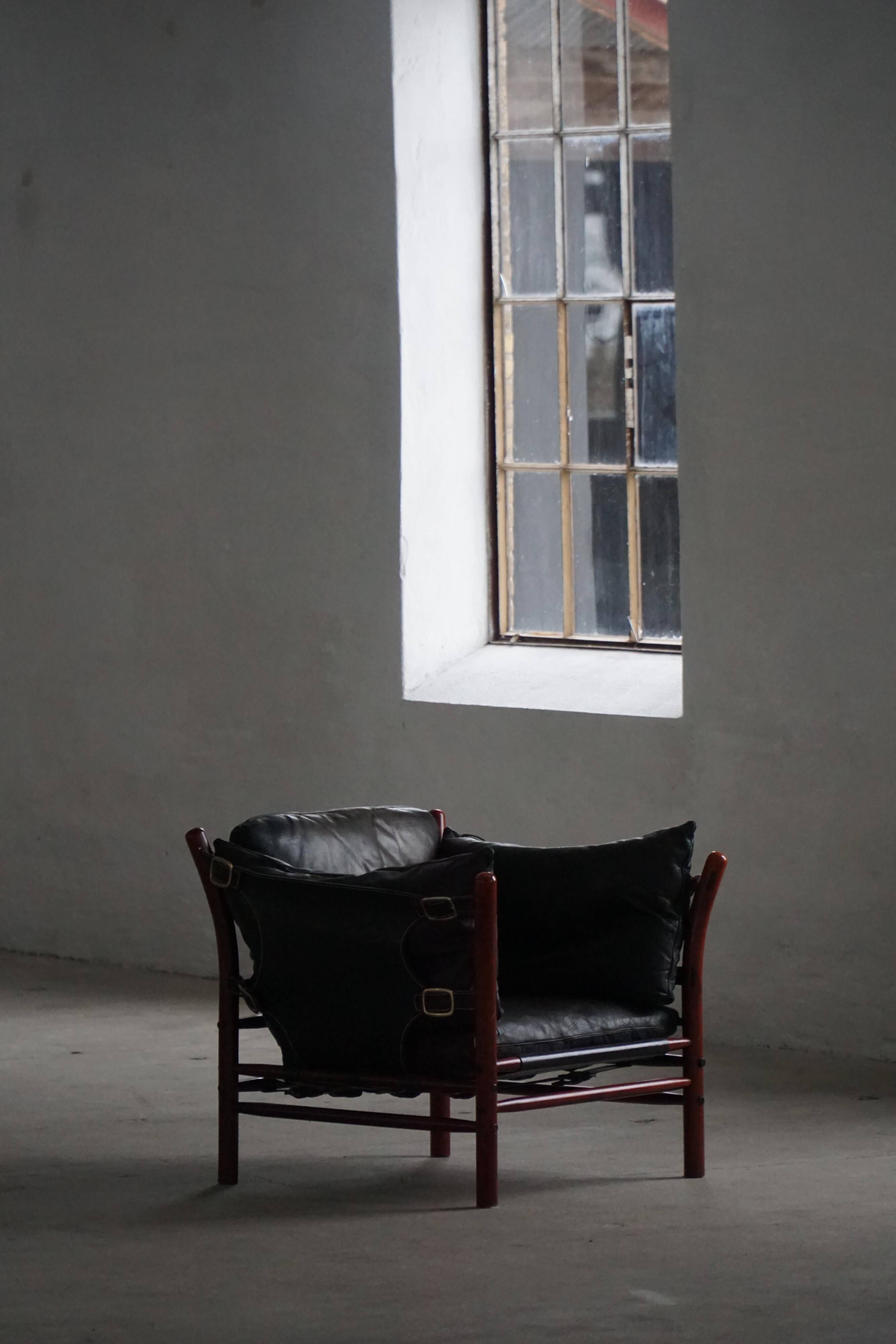 "Lounge chair 'Ilona' by Arne Norell in stained beech and leather, mid-20th century."