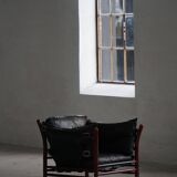 "Lounge chair 'Ilona' by Arne Norell in stained beech and leather, mid-20th century."