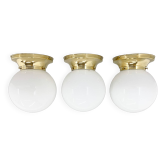 Set of three mid-century brass and milk glass ceiling ligts, restored