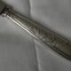 Set of 12 knives with silver metal handles and stainless steel blades.
