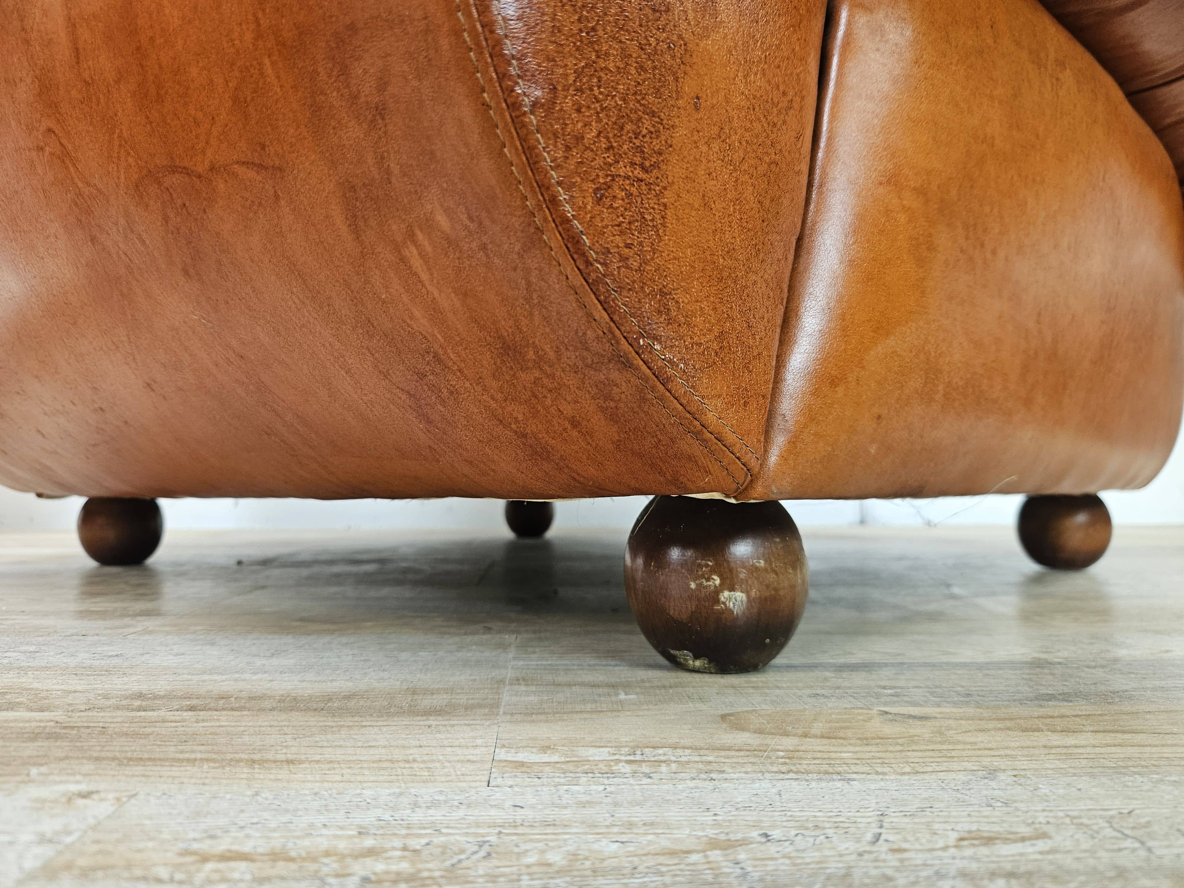 2 fauteuils en cuir cognac, années 1970