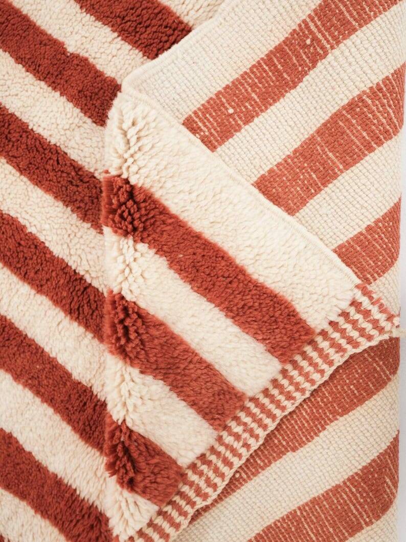 A handmade Moroccan striped terracotta rug, 150/250cm