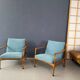 A pair of turquoise armchairs