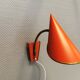 Danish red lacquered wall light with brass details. Estimated 1980s