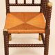 Fireplace corner chair in Louis XIII style, turned wood with braided rush, 19th century.