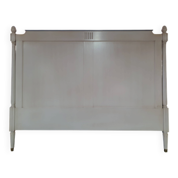 White headboard in Napoleon style with brass feet.