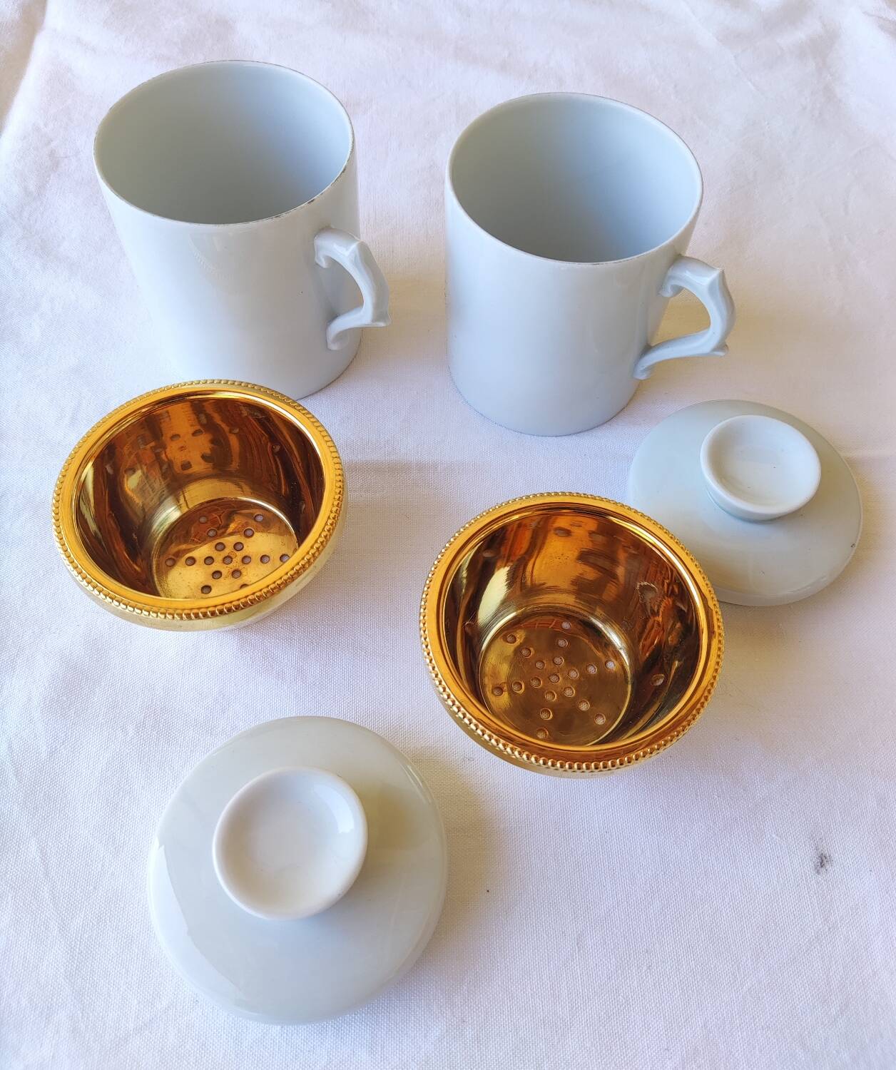 2 white and gold Limoges porcelain tea cups