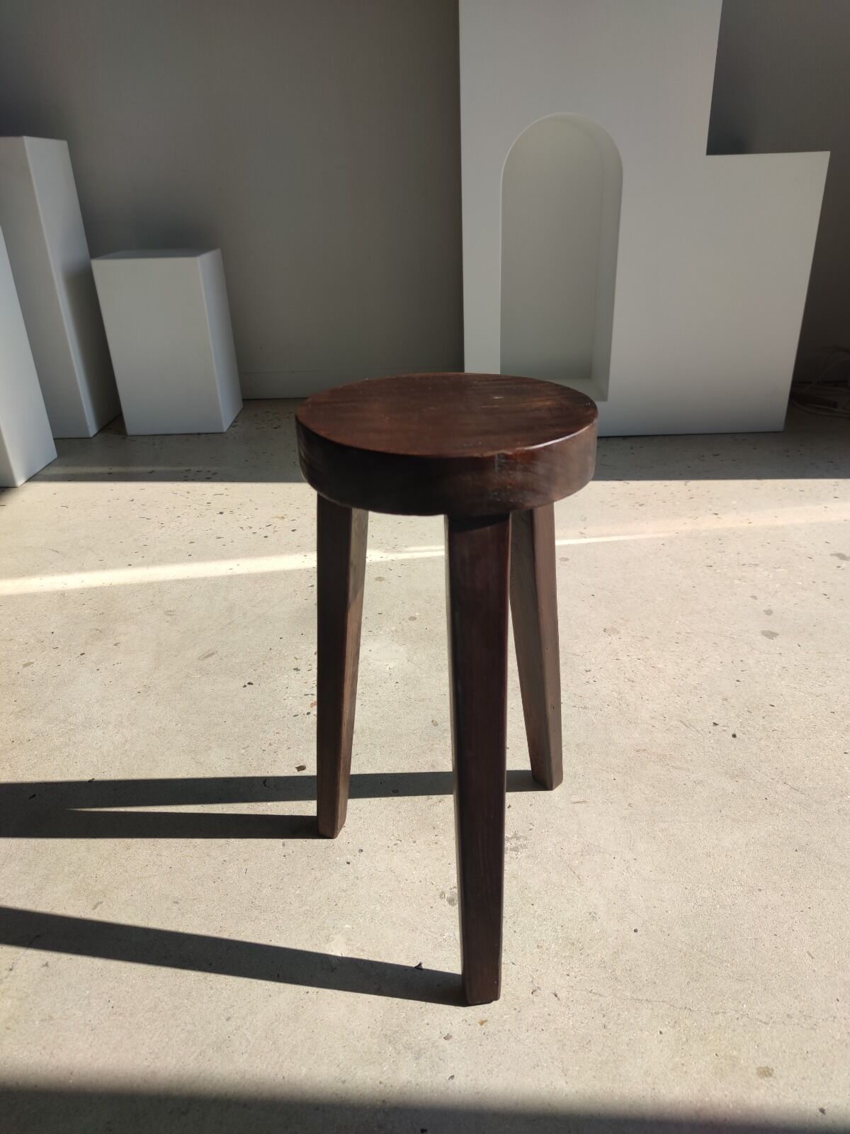 Small high tripod stool in brown solid wood