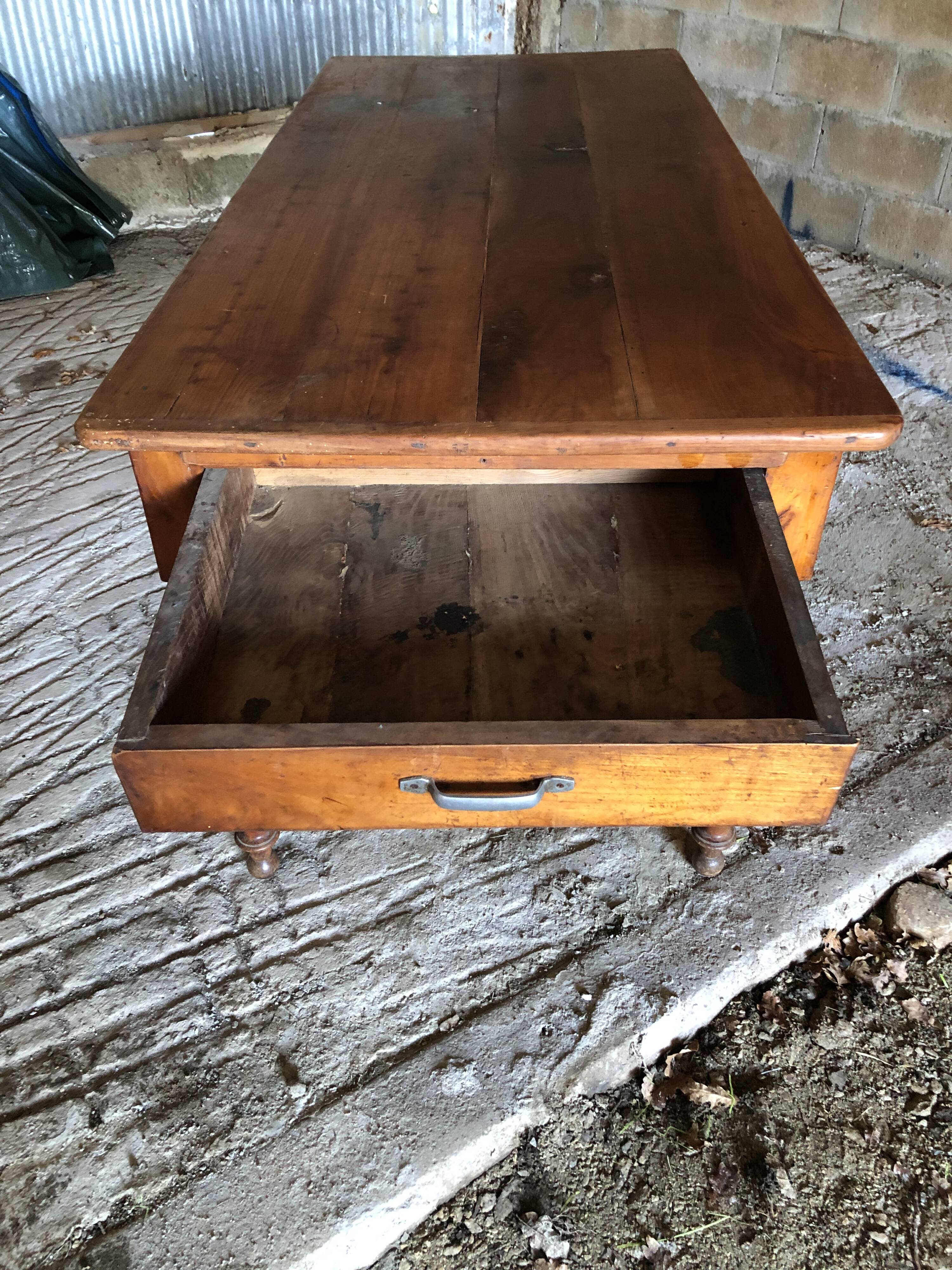 Antique Louis Philippe style farm table in solid cherry wood with turned base.