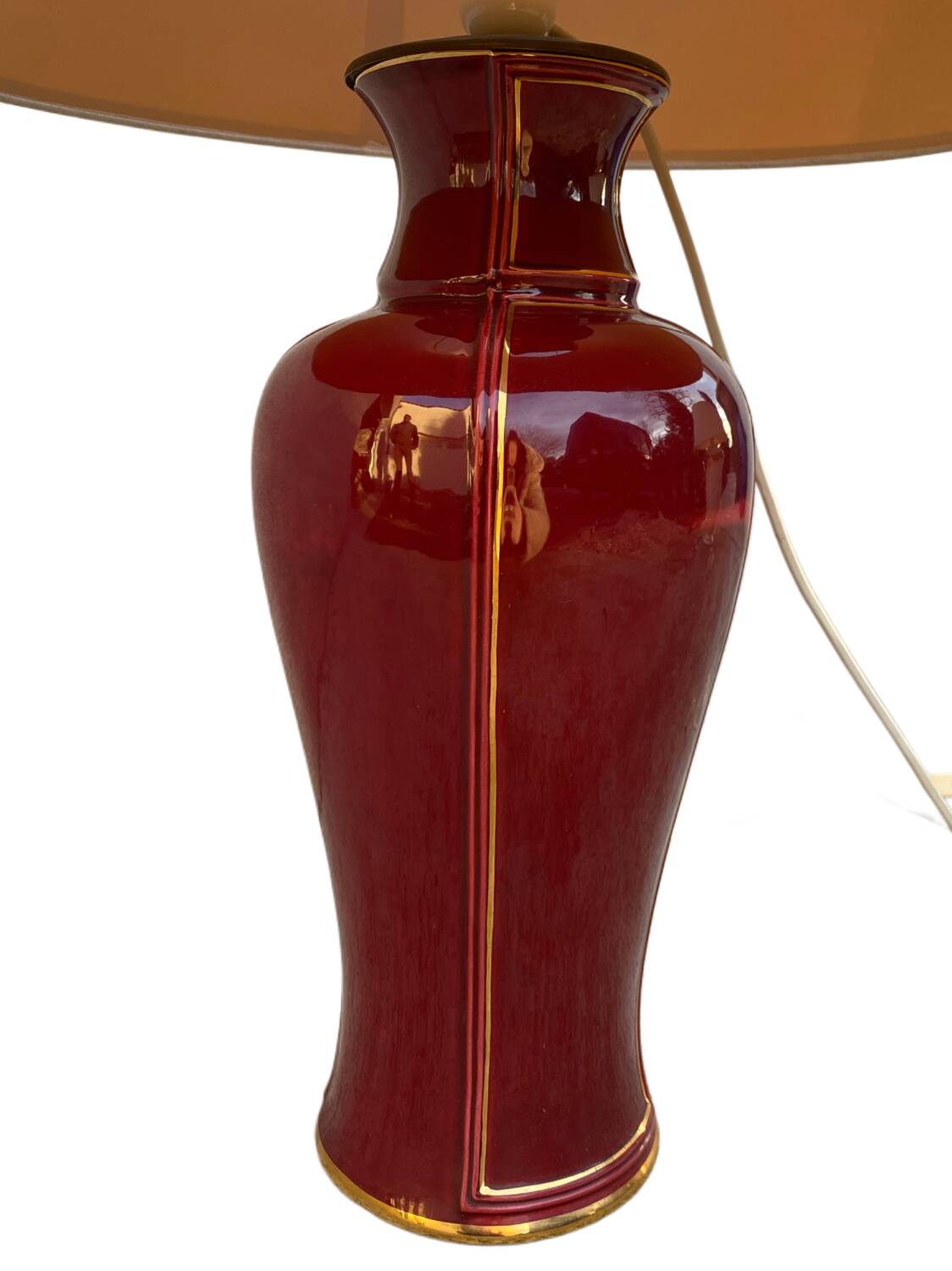 Large burgundy and gold table lamp in vase style.