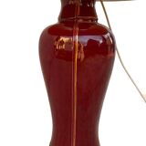 Large burgundy and gold table lamp in vase style.