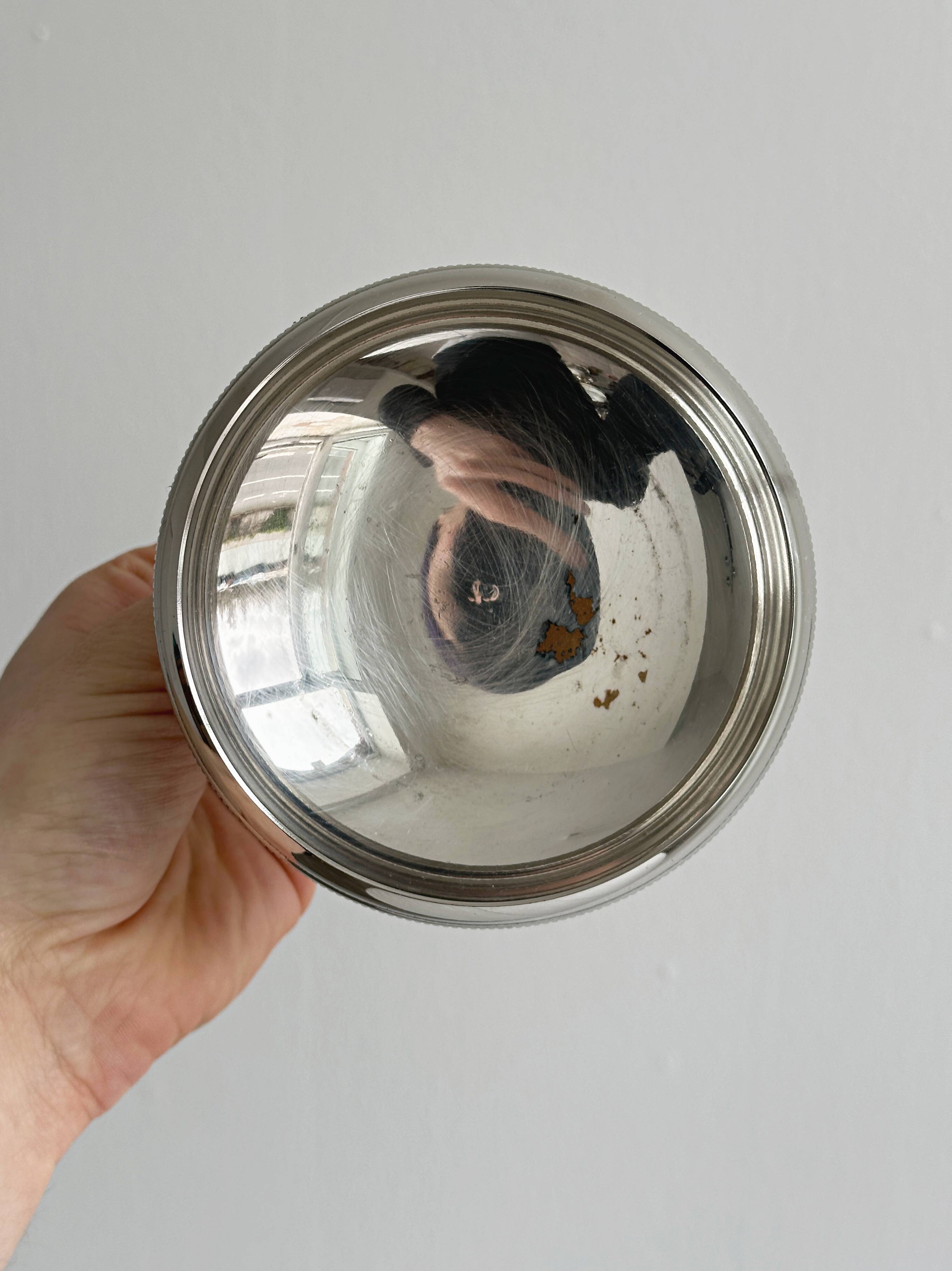 Small silver-plated metal bowl on a stand.