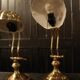Pair of articulated brass lamps in the shape of a shell.