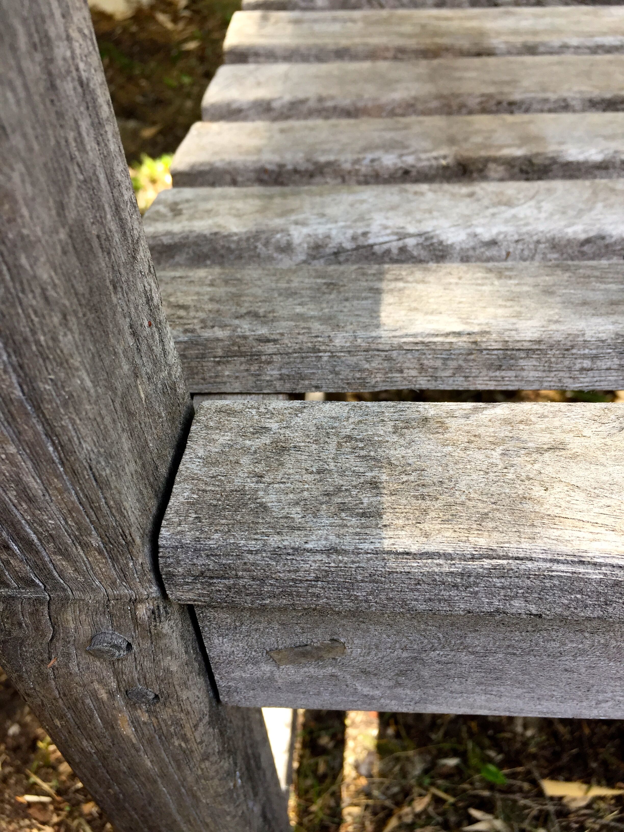 Vintage wooden garden bench with wheels